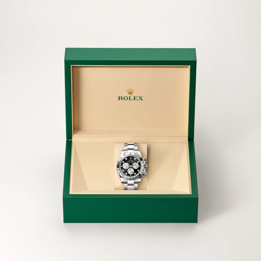 Rolex Cosmograph Daytona in 18 ct white gold with a Bright black and steel set with diamonds dial, Fixed, with engraved tachymetric scale, in 18 ct white gold bezel, Oyster, three-piece solid links bracelet